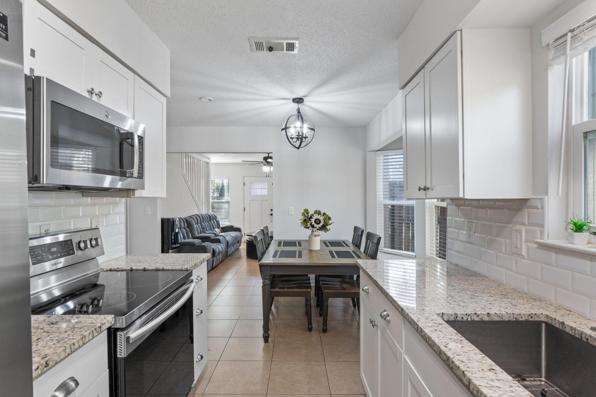 73 Kelly Way Valparaiso, FL 32580 - Photo 10 of 22 a kitchen with granite countertop stainless steel appliances a sink stove and microwave