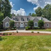 a front view of a house with swimming pool having outdoor seating
