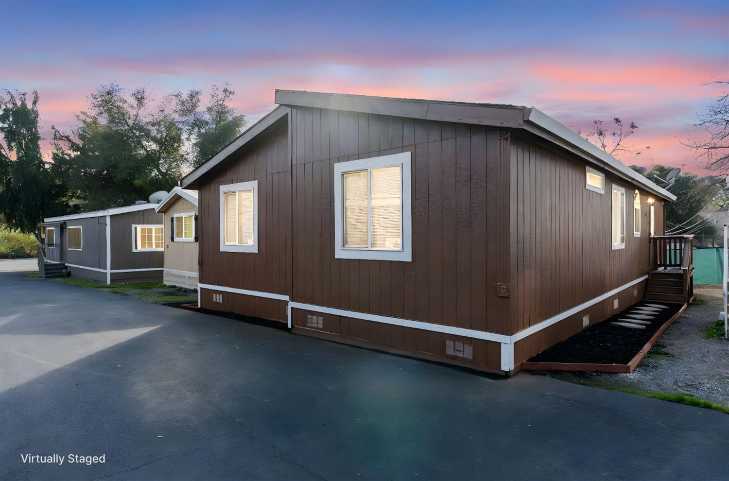 a backyard of a house with lots of green space and outdoor seating