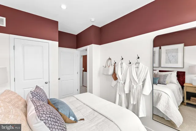 a bedroom with a bed and a white cabinet