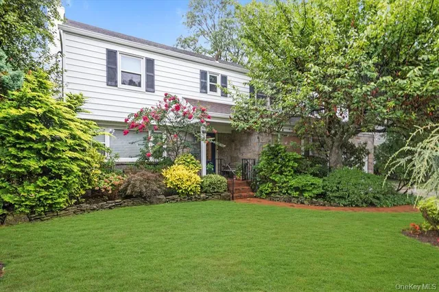 a front view of a house with a garden