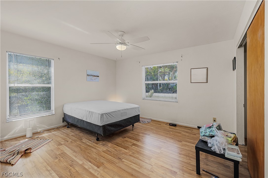 12170 Dolphin Road Bokeelia, FL 33922 - Photo 11 of 23 a living room with a bed furniture and a window
