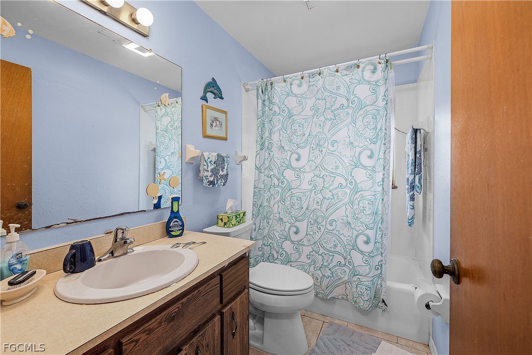 12170 Dolphin Road Bokeelia, FL 33922 - Photo 13 of 23 a bathroom with a sink toilet and shower