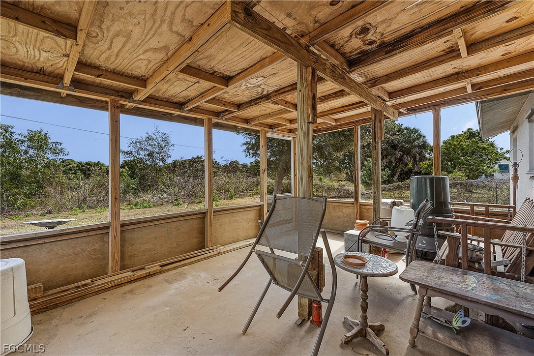 12170 Dolphin Road Bokeelia, FL 33922 - Photo 14 of 23 a view of a patio with table and chairs and potted plants