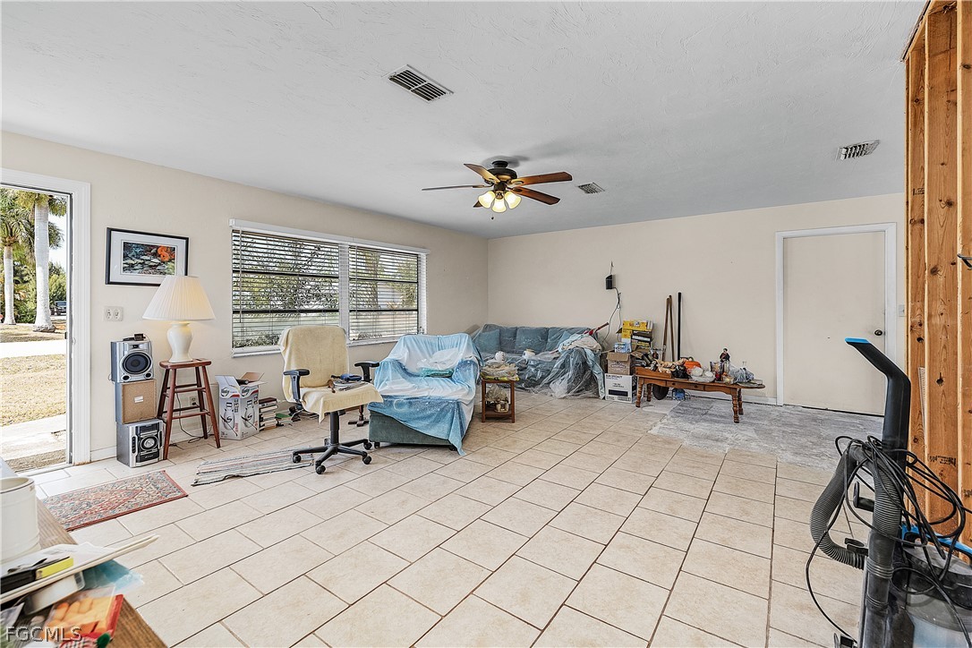 12170 Dolphin Road Bokeelia, FL 33922 - Photo 4 of 23 a living room with furniture and a flat screen tv