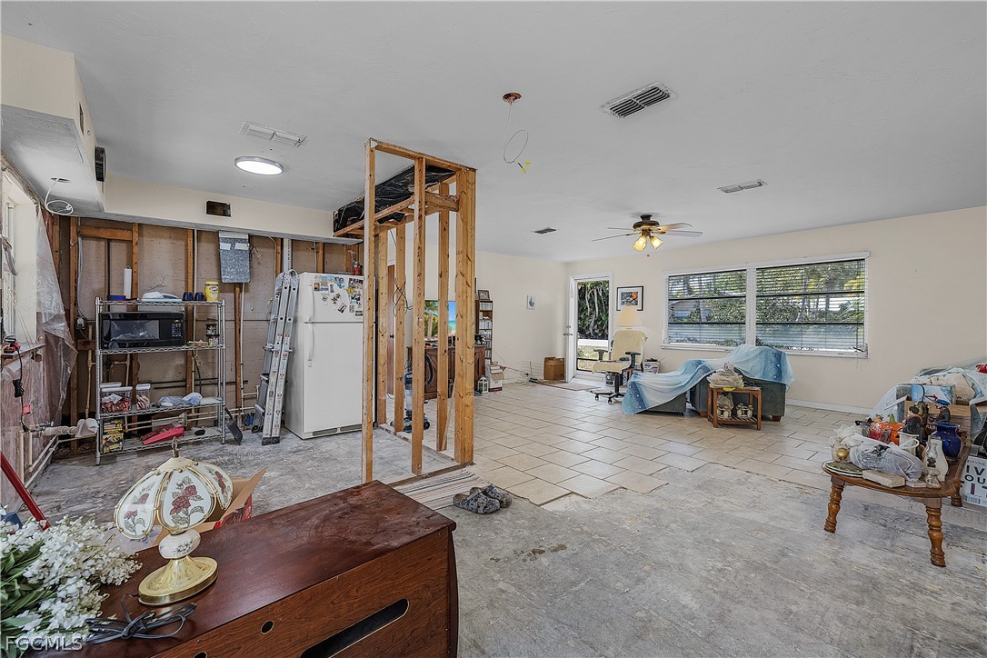 12170 Dolphin Road Bokeelia, FL 33922 - Photo 5 of 23 a living room with furniture and a large window