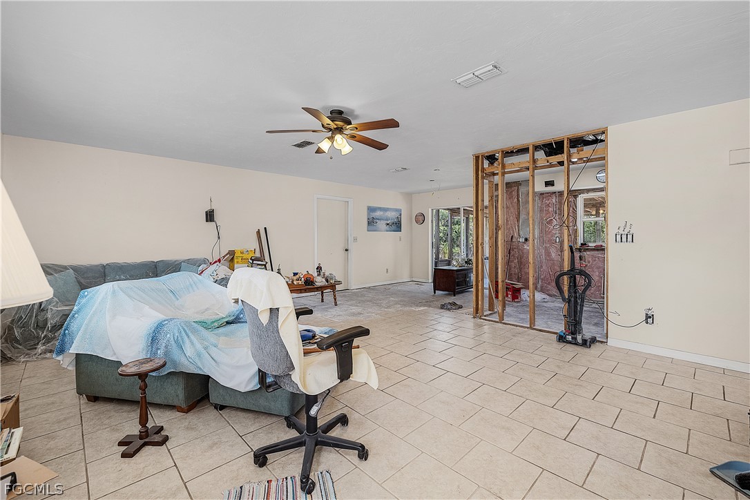 12170 Dolphin Road Bokeelia, FL 33922 - Photo 7 of 23 a bedroom with furniture and a ceiling fan