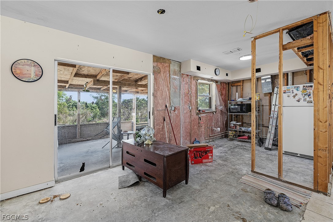 12170 Dolphin Road Bokeelia, FL 33922 - Photo 8 of 23 a living room with furniture and a large window