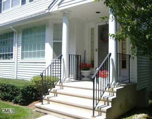 180 Turn Of River Road, Unit 9C Stamford, CT 06905 - Photo 1 of 1 a view of a house with large windows and stairs