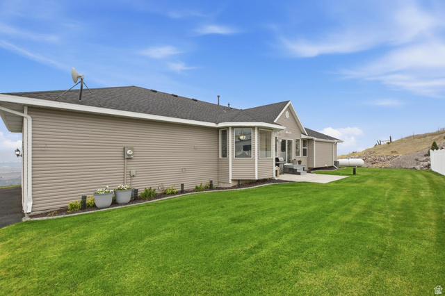 560 East Lower Rock Creek Road Inkom, ID 83245 - Photo 2 of 44 Expansive green lawn bordering the house, featuring a side patio and an octagonal bay window
