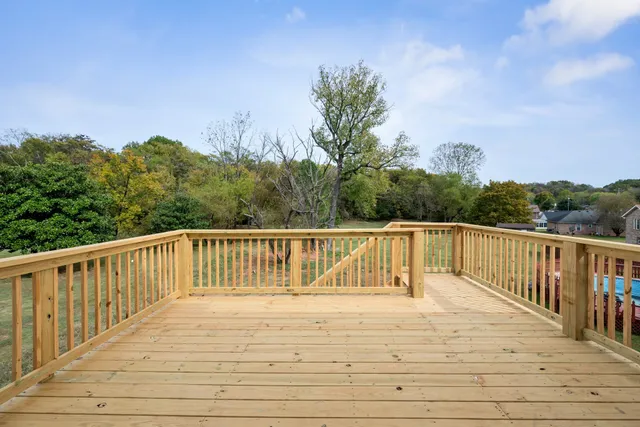 a view of balcony with wooden floor and fence