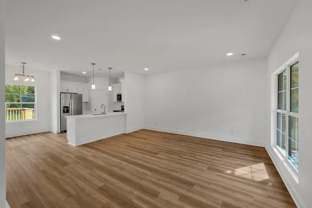 a view of kitchen with stainless steel appliances refrigerator oven and cabinets