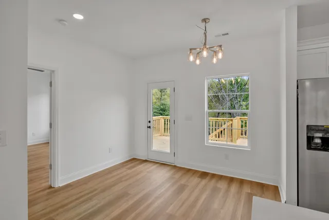 an empty room with a window and a ceiling fan