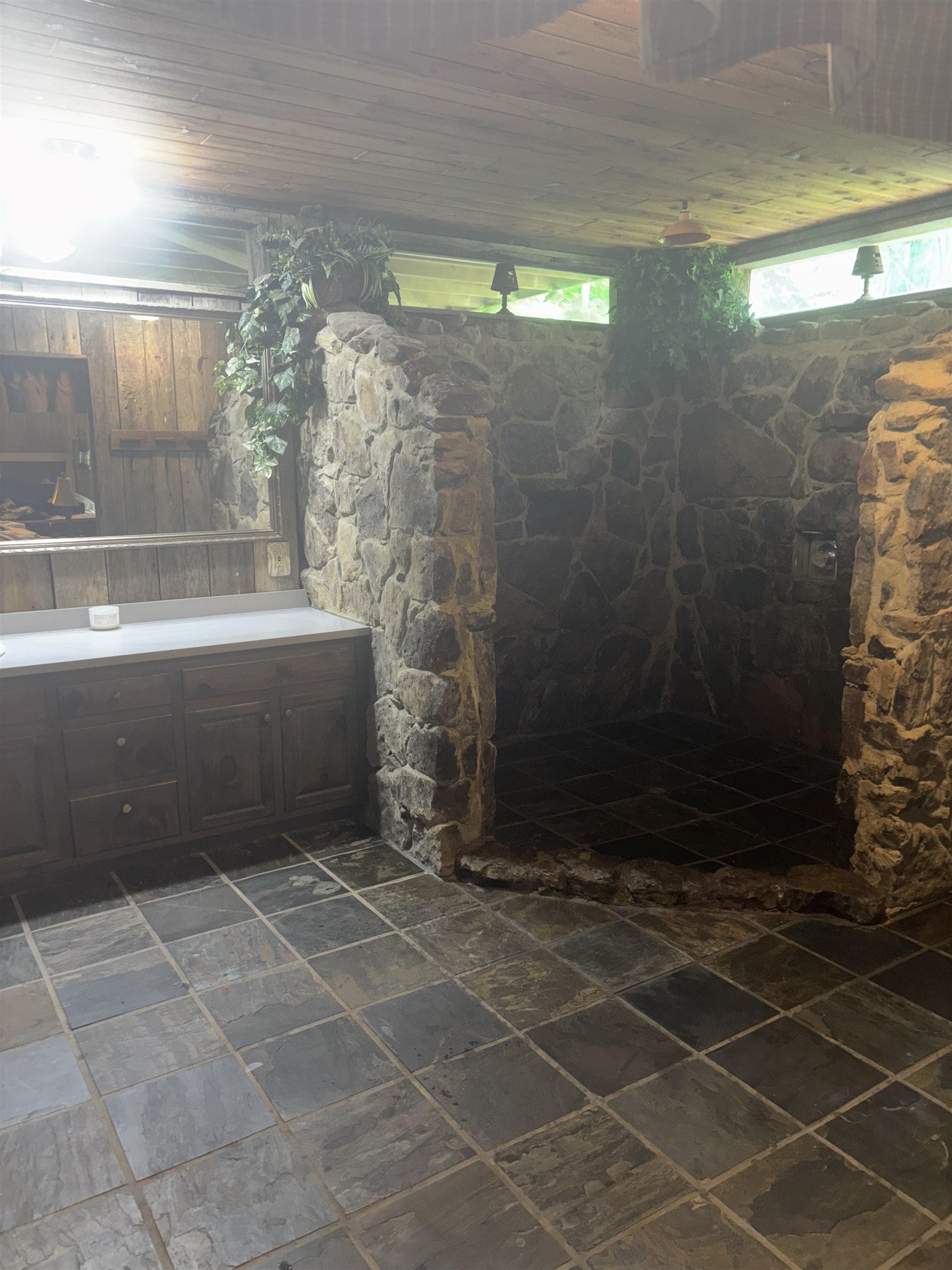 7462 Campground Road Drummonds, TN 38023 - Photo 17 of 31 Stone-clad shower enclosure, stone floor tiling, wood-finish ceiling, built-in vanity with countertop