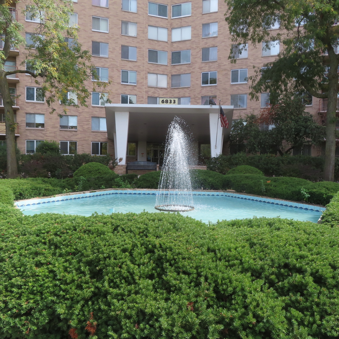 a front view of a building with garden