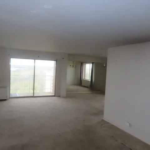 an empty room with windows and outdoor view