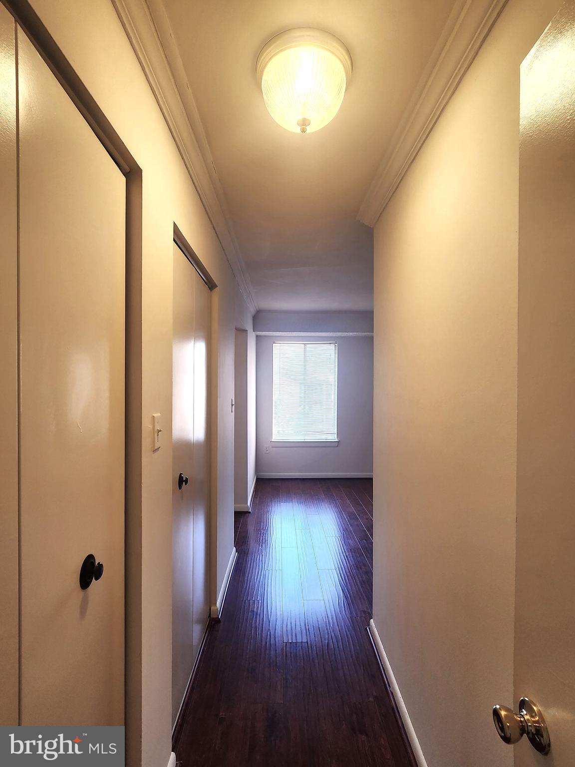 7919 Mandan Road, Unit 304 Greenbelt, MD 20770 - Photo 12 of 21 a view of a hallway with wooden floor and closet