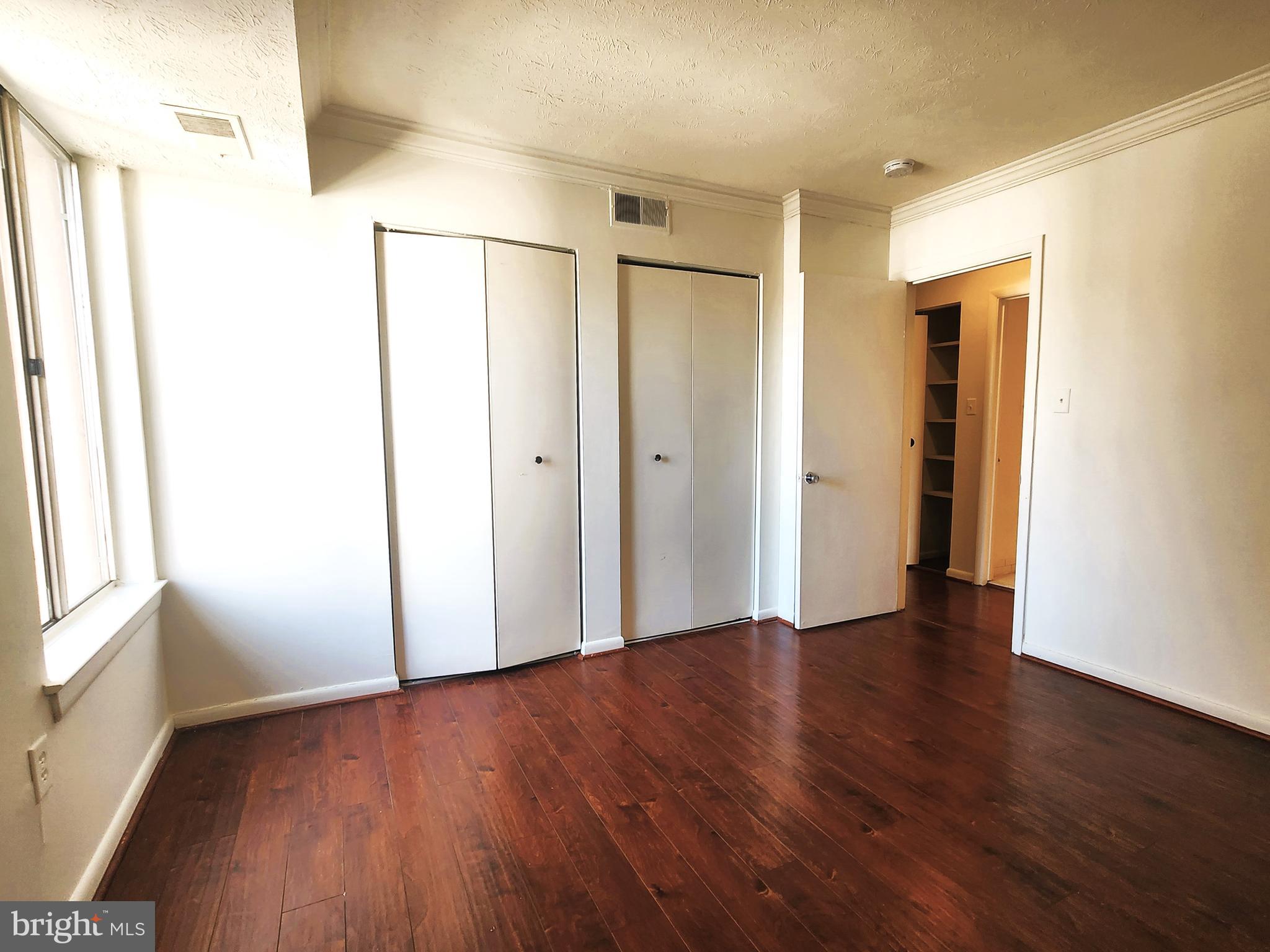 7919 Mandan Road, Unit 304 Greenbelt, MD 20770 - Photo 13 of 21 a view of a big room with wooden floor and windows