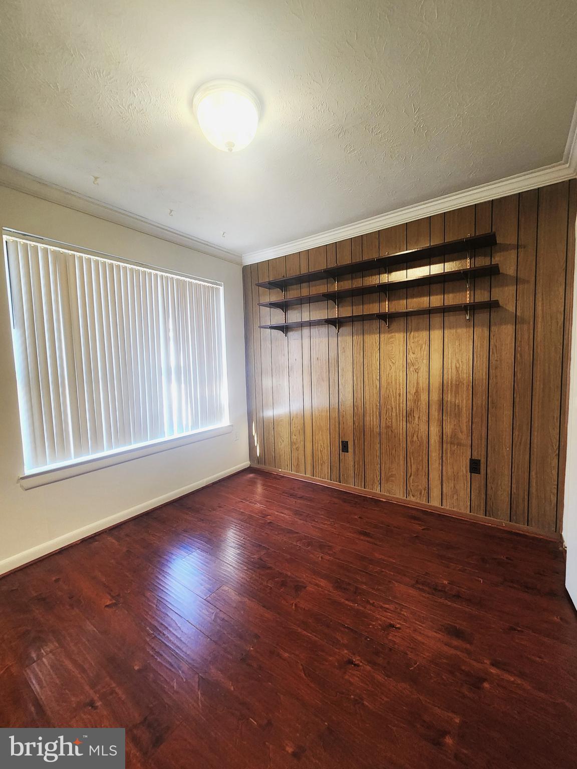 7919 Mandan Road, Unit 304 Greenbelt, MD 20770 - Photo 15 of 21 a view of an empty room with wooden floor and a window