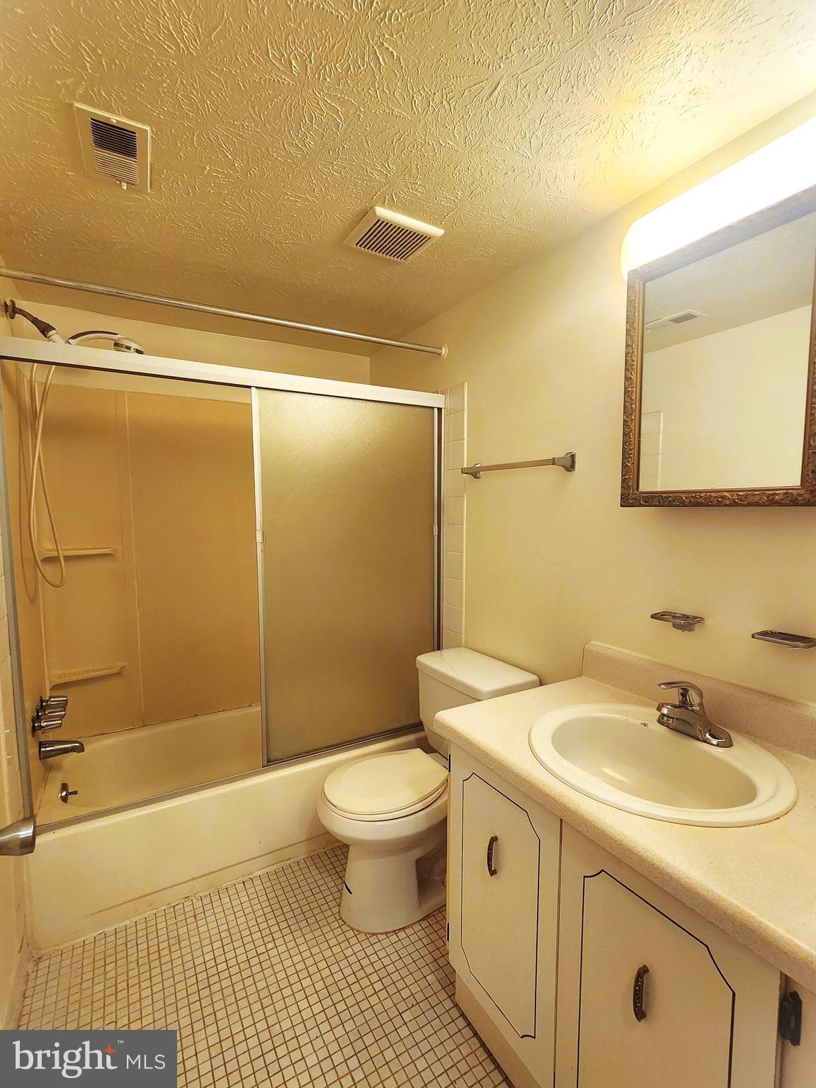 7919 Mandan Road, Unit 304 Greenbelt, MD 20770 - Photo 18 of 21 a bathroom with a sink a toilet and shower