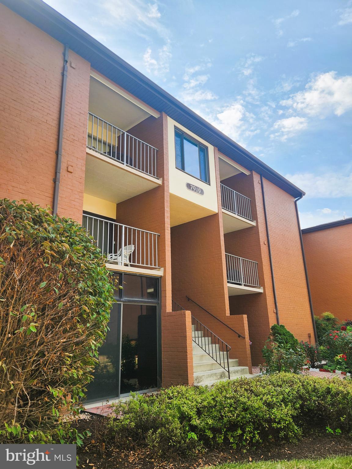 7919 Mandan Road, Unit 304 Greenbelt, MD 20770 - Photo 2 of 21 a front view of a house with a yard