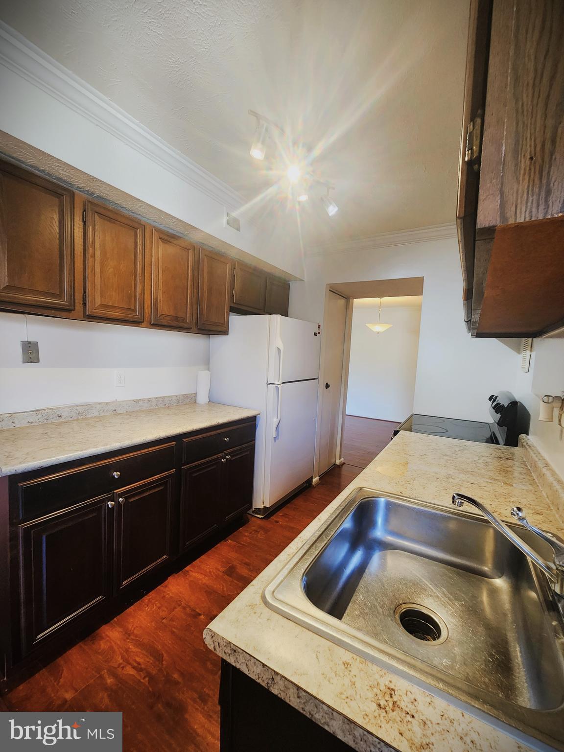 7919 Mandan Road, Unit 304 Greenbelt, MD 20770 - Photo 3 of 21 a kitchen with a sink stove and cabinets