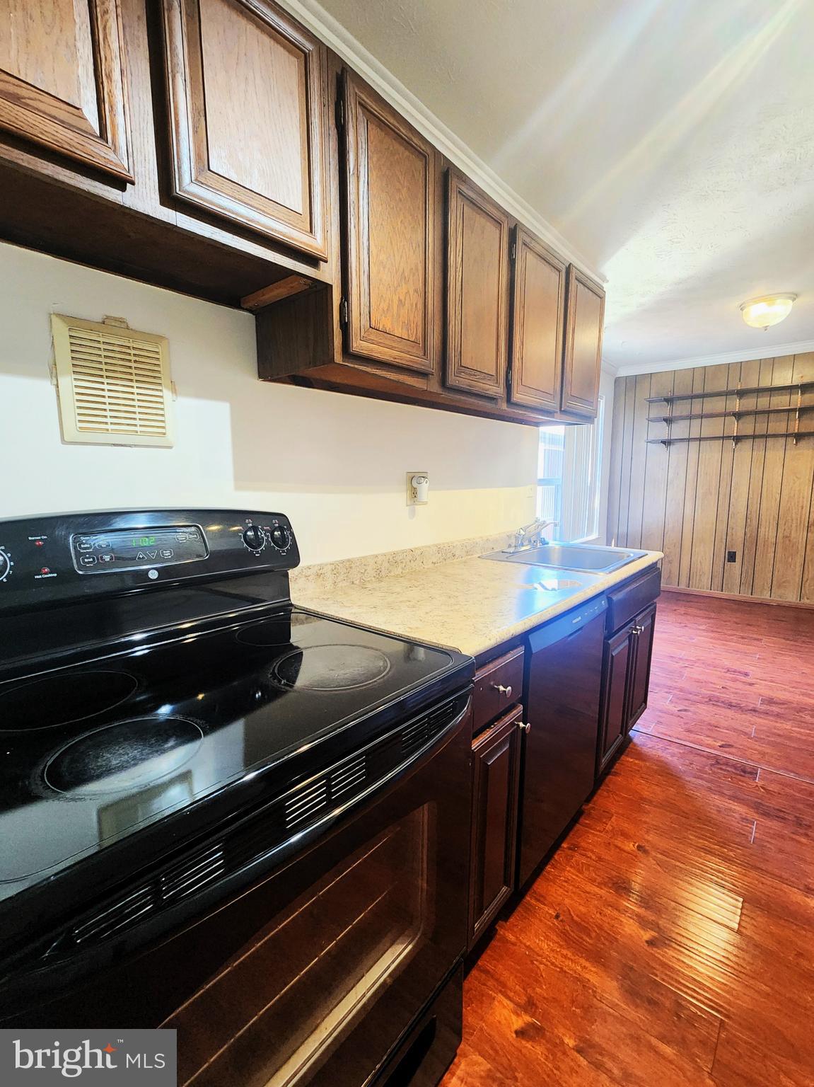 7919 Mandan Road, Unit 304 Greenbelt, MD 20770 - Photo 4 of 21 a kitchen with wooden cabinets and a stove top oven