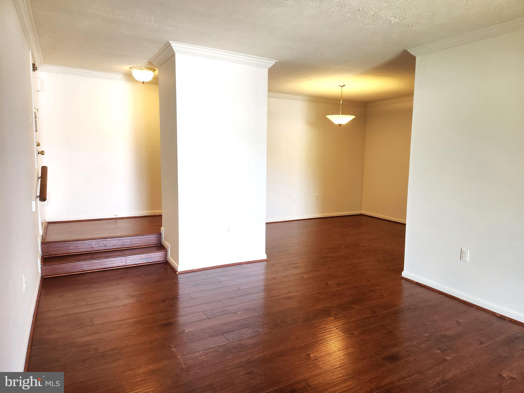 7919 Mandan Road, Unit 304 Greenbelt, MD 20770 - Photo 9 of 21 a view of an empty room with wooden floor