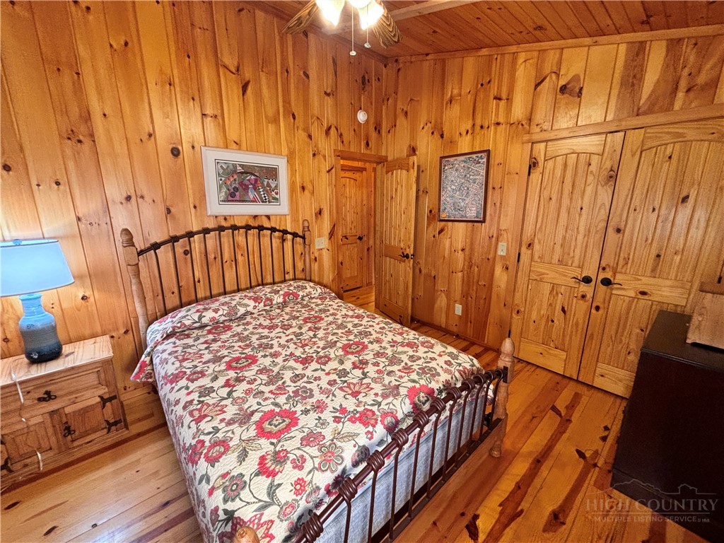 150 Turkey Ridge Crumpler, NC 28617 - Photo 30 of 40 a bedroom with a bed and wooden floor