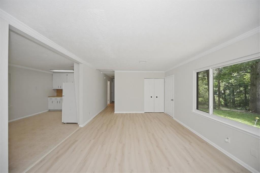 142 Deer Run Canton, GA 30114 - Photo 13 of 24 a view of a big room with wooden floor and windows