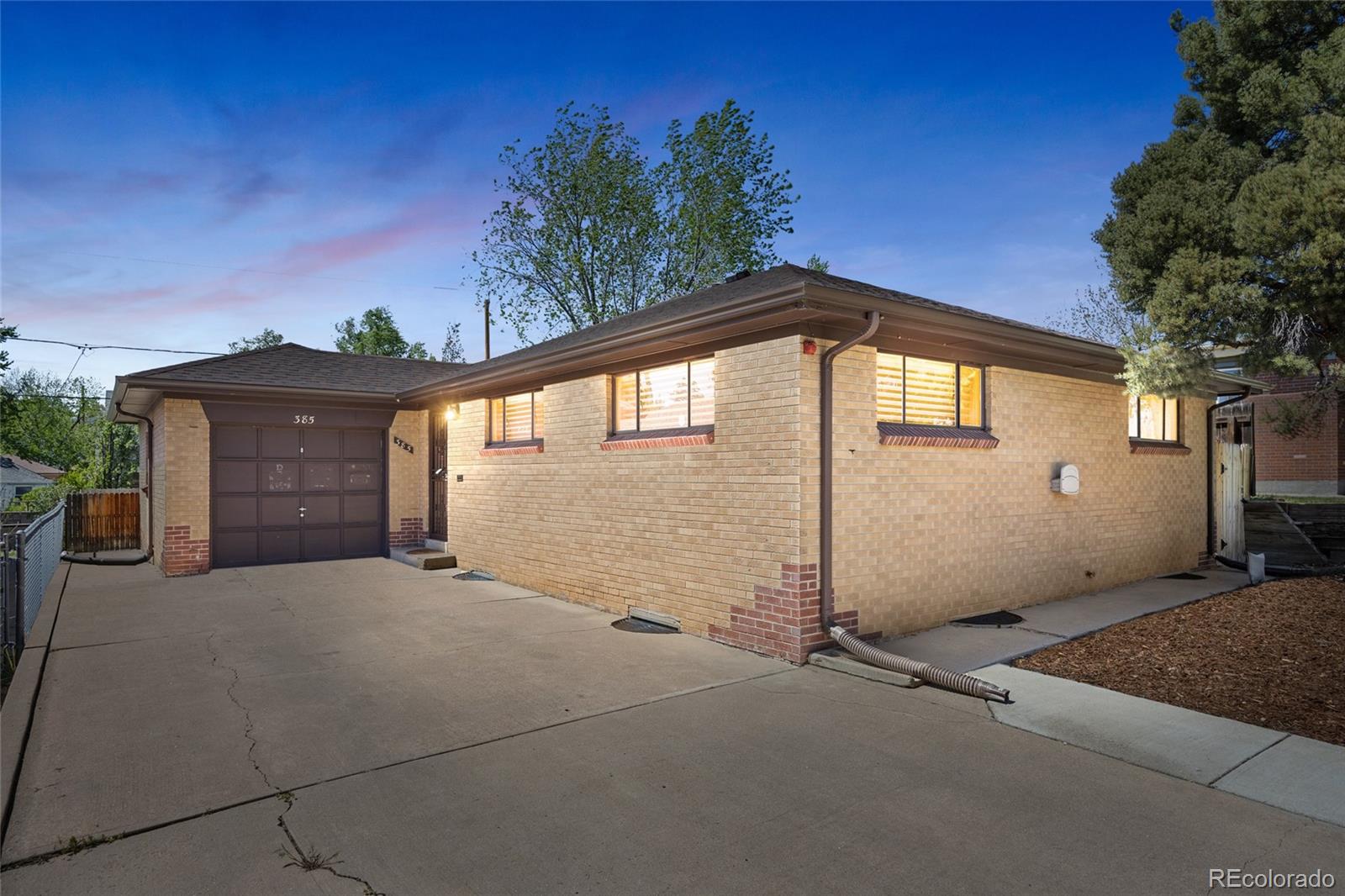 385 South Kearney Street Denver, CO 80224 - Photo 1 of 43 a front view of a house with a garage