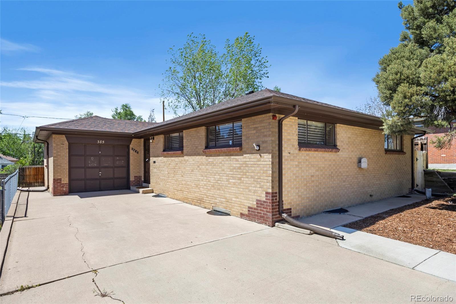 385 South Kearney Street Denver, CO 80224 - Photo 2 of 43 a front view of a house with a garage