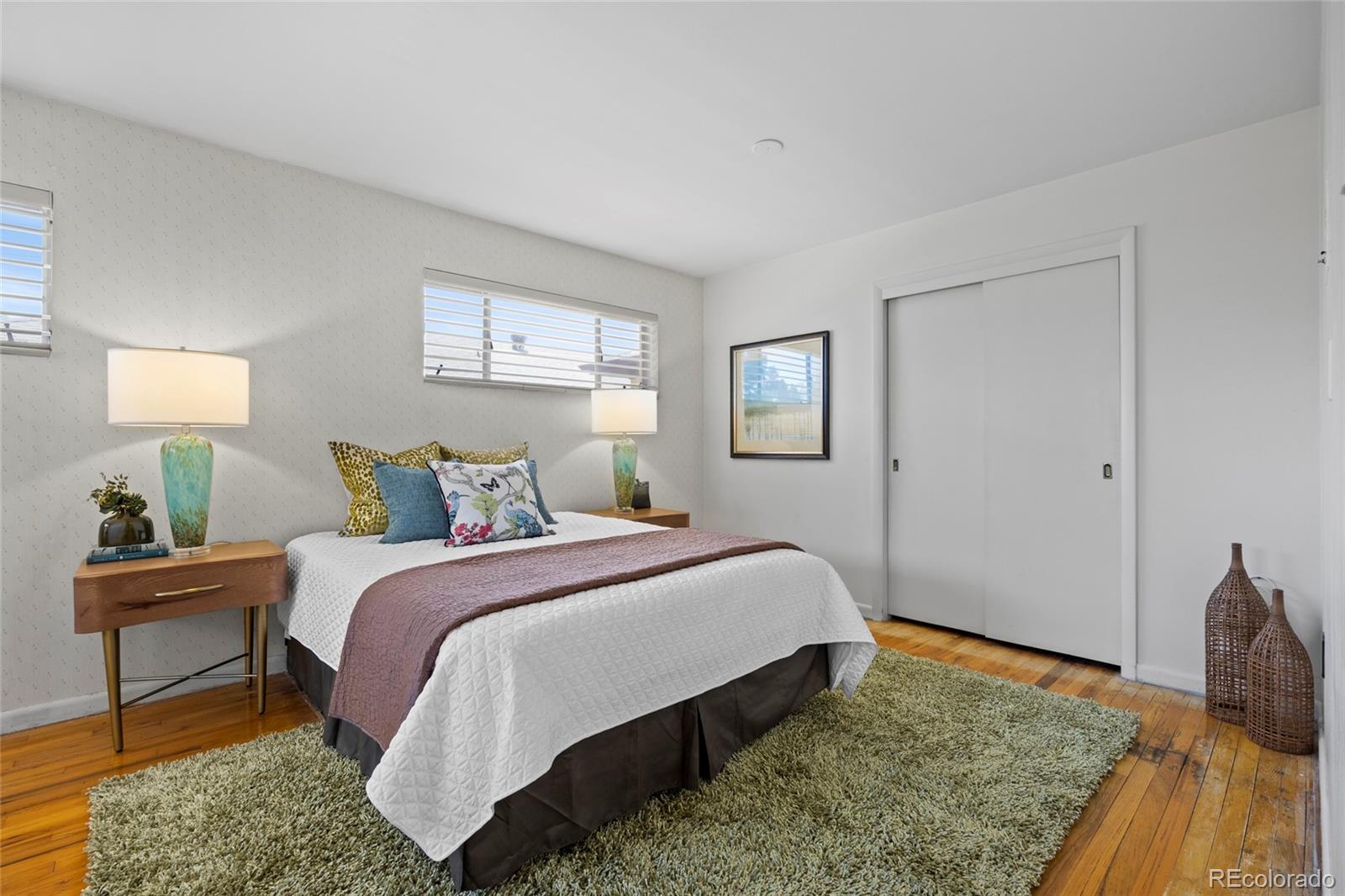 385 South Kearney Street Denver, CO 80224 - Photo 21 of 43 a bedroom with a bed and wooden floor