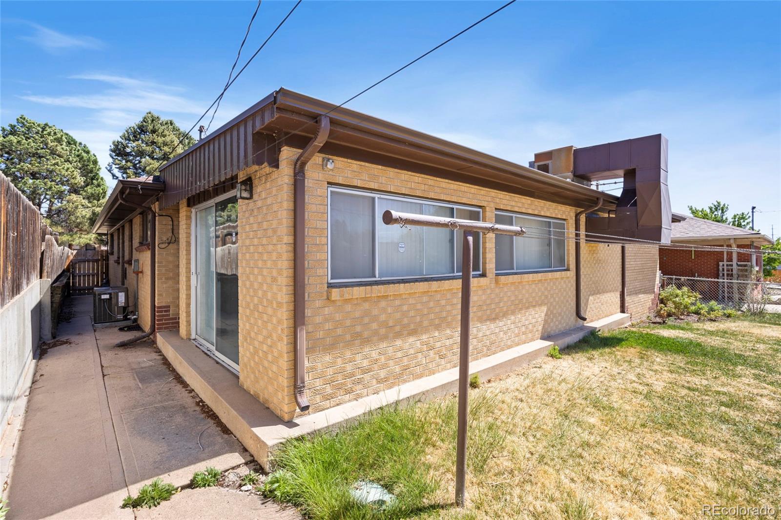 385 South Kearney Street Denver, CO 80224 - Photo 37 of 43 a view of a house with a small yard and wooden fence
