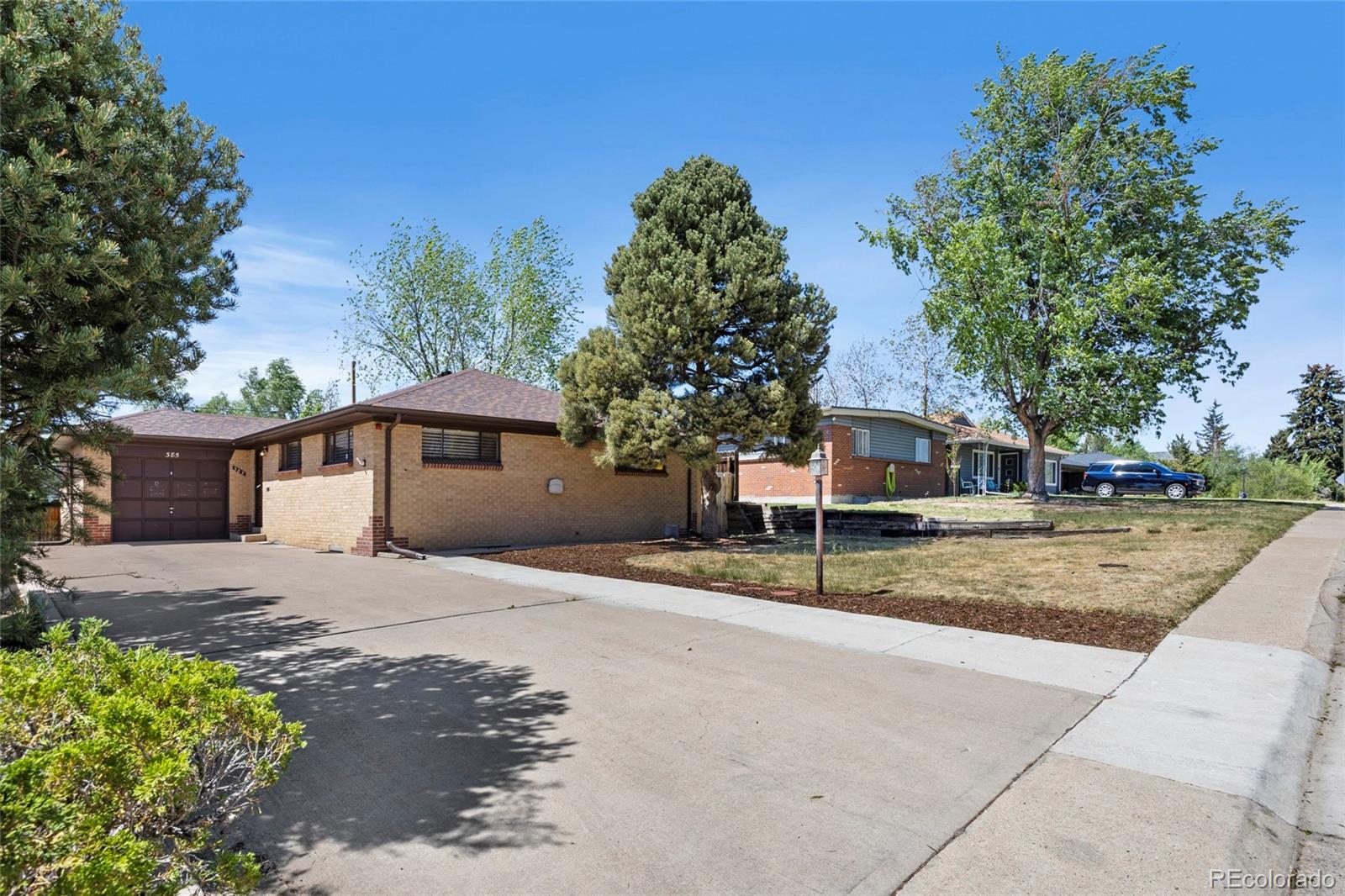 385 South Kearney Street Denver, CO 80224 - Photo 4 of 43 a house with a tree in front of it