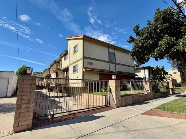 a view of a house with iron fence