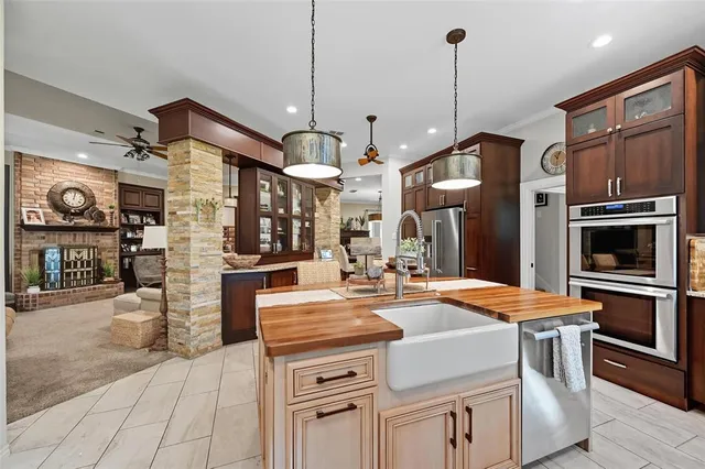 a kitchen with stainless steel appliances granite countertop a stove oven and a kitchen island