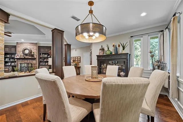 a dining room with furniture window and wooden floor
