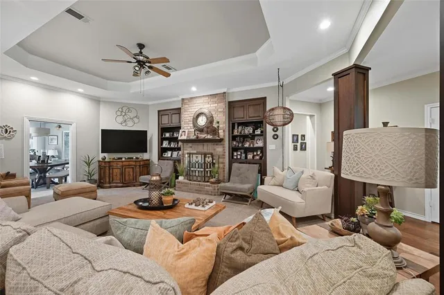 a living room with furniture a flat screen tv and a fireplace