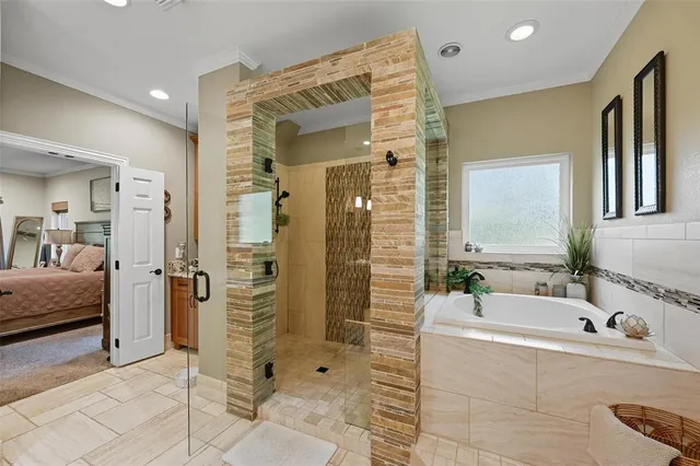 a bathroom with a tub sink shower and mirror