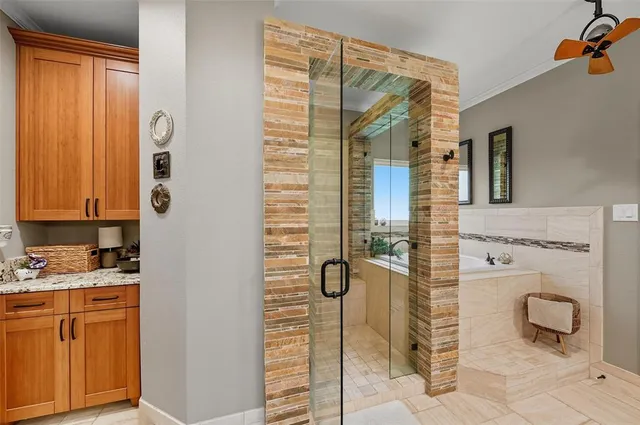 a bathroom with a granite countertop shower and a sink