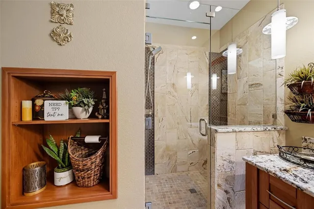 a bathroom with a glass shower door and a sink