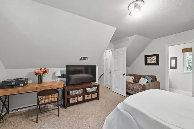 a bedroom with furniture and a flat screen tv