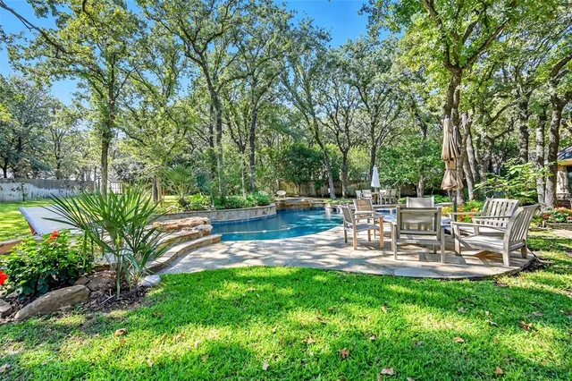 a view of a chair and table in backyard