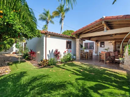 a view of a backyard with sitting area and garden