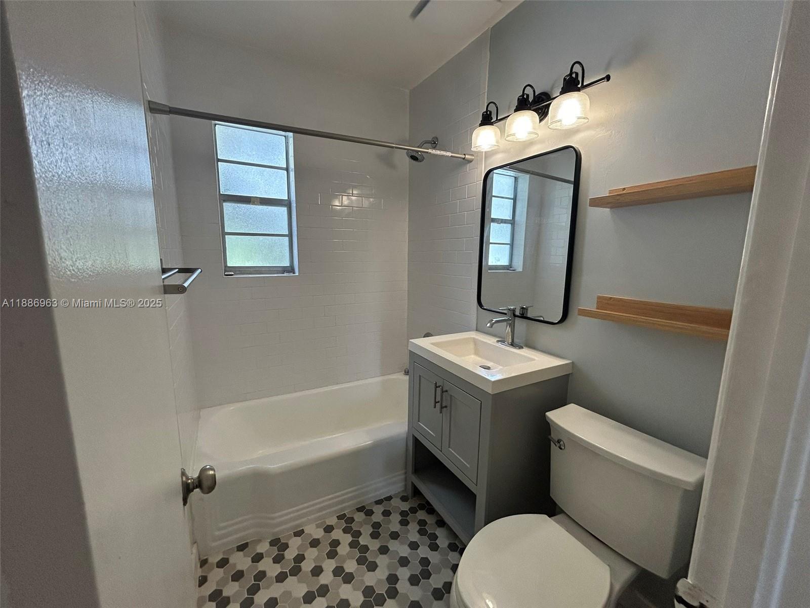 7865 Southwest 57th Avenue, Unit 47C Miami, FL 33143 - Photo 11 of 20 a bathroom with a sink a toilet and shower