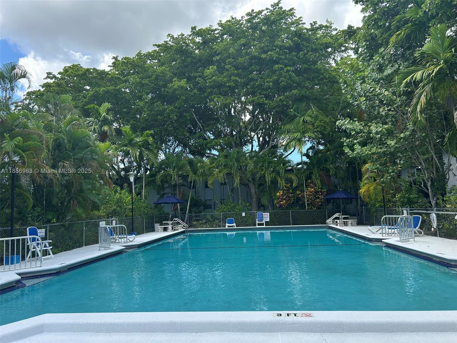 7865 Southwest 57th Avenue, Unit 47C Miami, FL 33143 - Photo 15 of 20 a view of a swimming pool with a patio