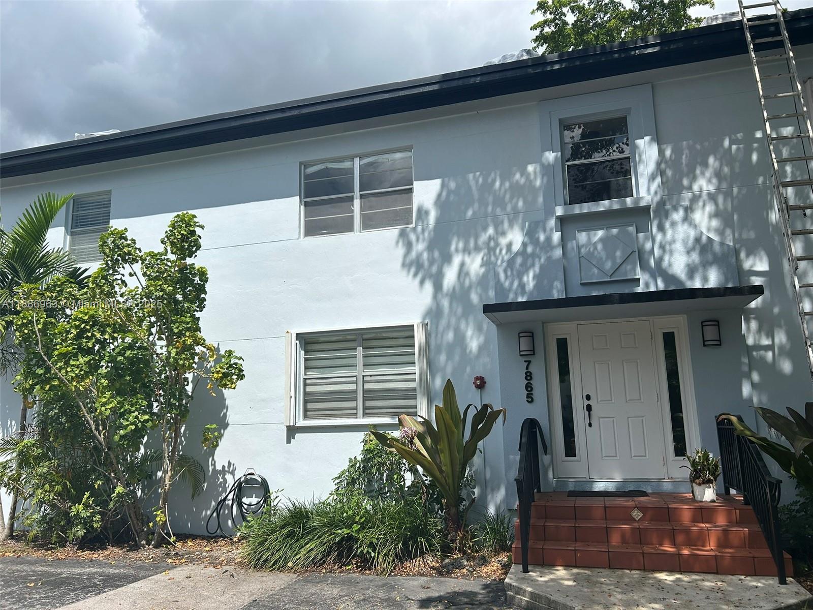 7865 Southwest 57th Avenue, Unit 47C Miami, FL 33143 - Photo 19 of 20 a front view of a house with garden