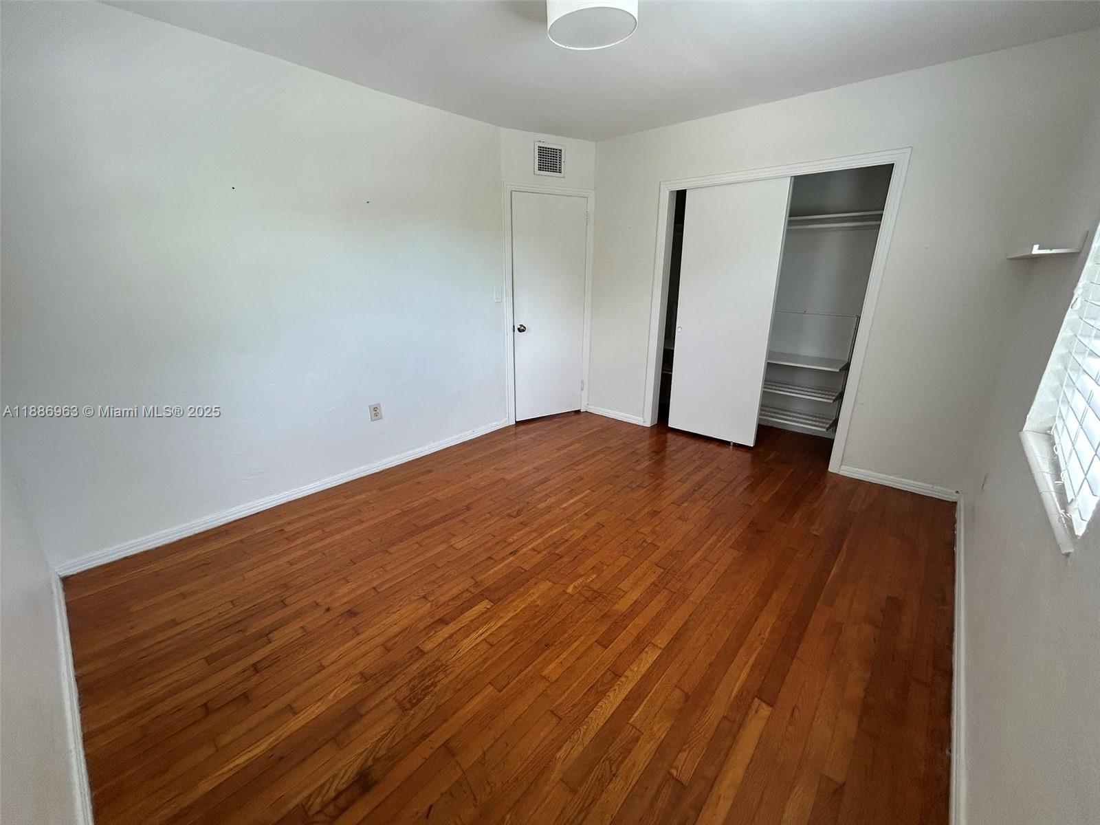 7865 Southwest 57th Avenue, Unit 47C Miami, FL 33143 - Photo 9 of 20 wooden floor in an empty room