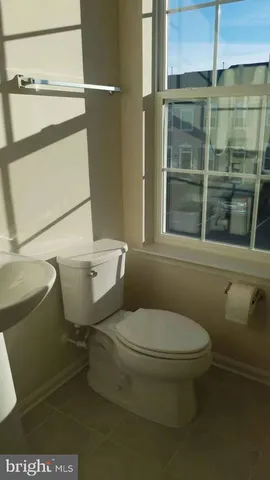 a white toilet sitting next to a bathroom sink